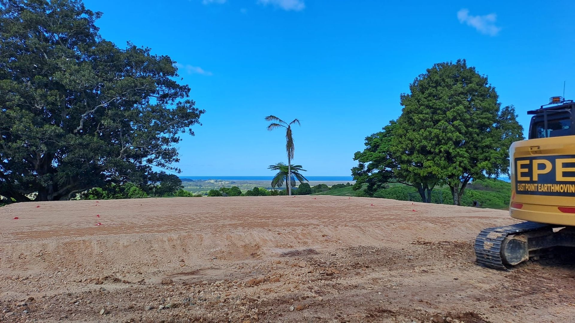 A Dirt Field Over Looking The Water — East Point Earthmoving in Byron Bay, NSW