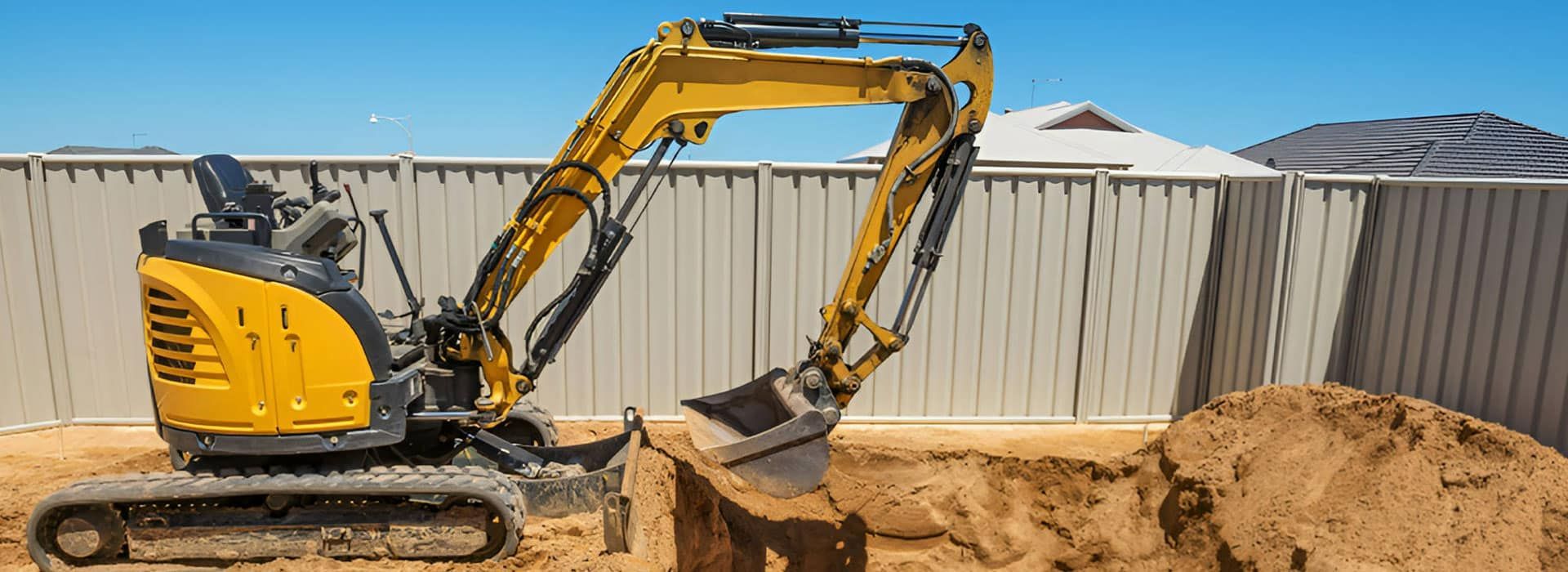 A Yellow Excavator Is Digging A Hole In The Dirt — East Point Earthmoving in Bangalow, NSW