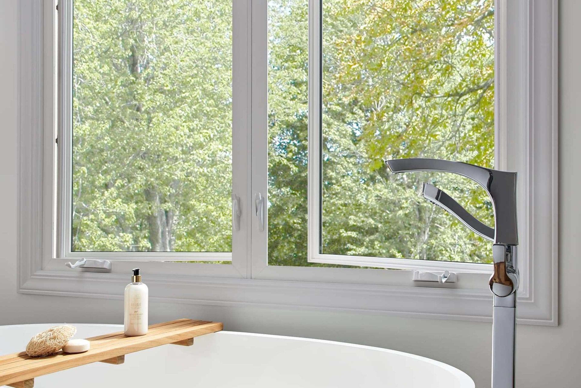 A close-up view of an open white window, highlighting the metal scissor-hinge mechanism attached to the frame.