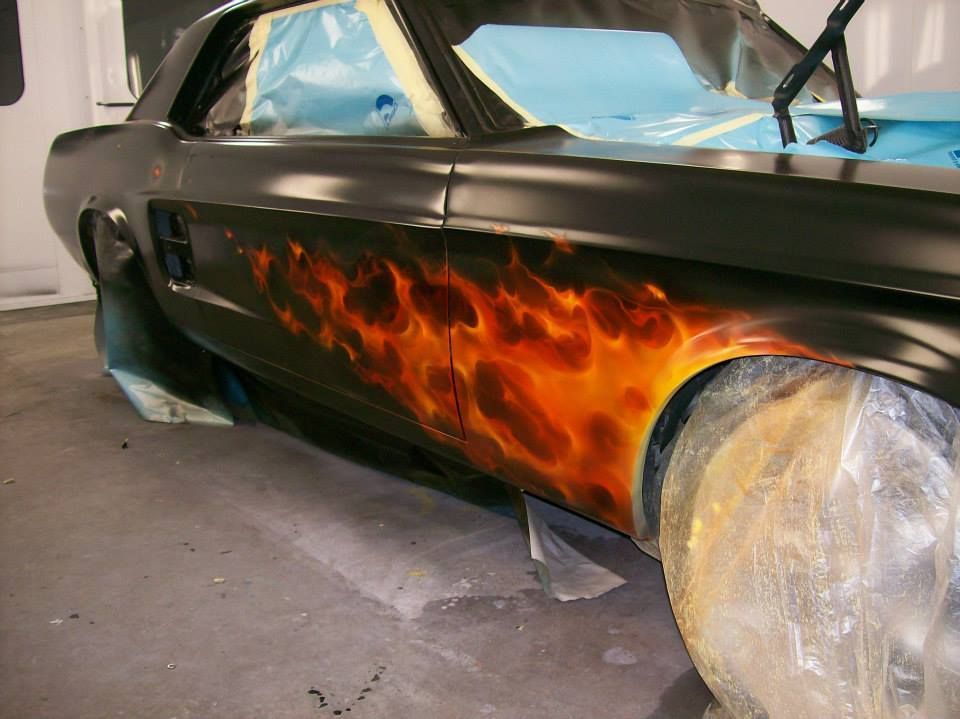 A black car with flames painted on the side