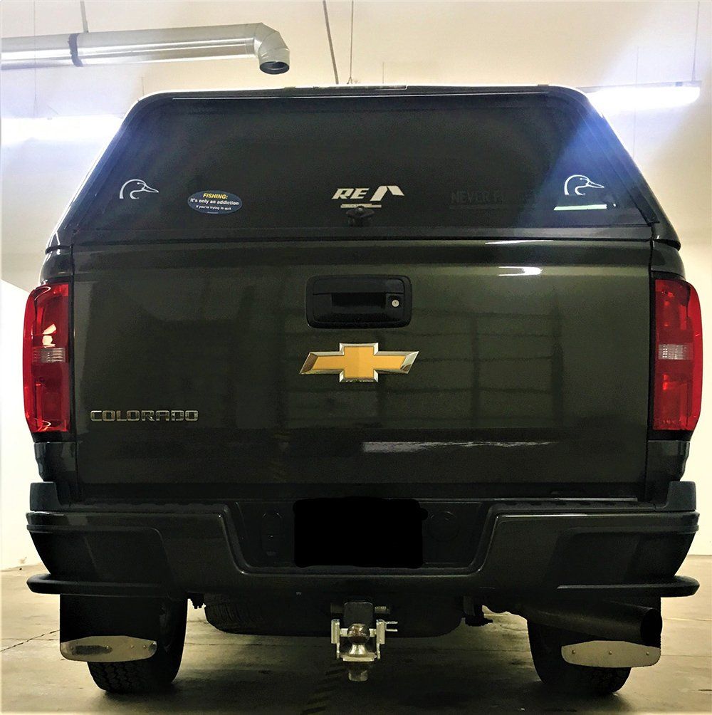 A chevrolet colorado truck is parked in a garage