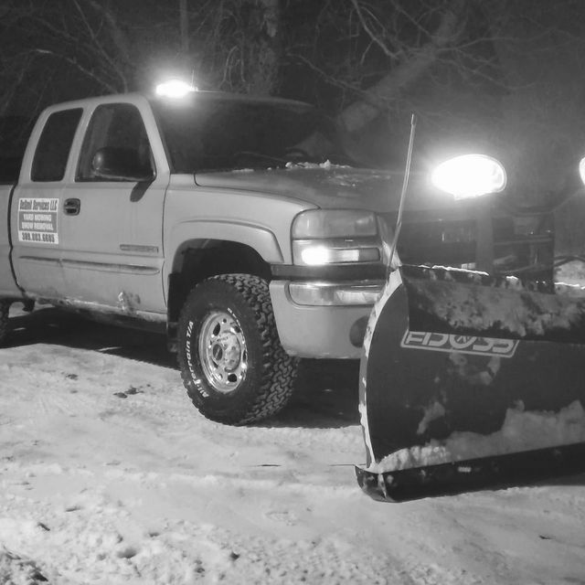 A truck with a snow plow attached to it