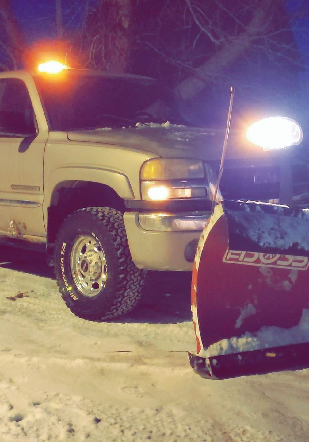 A snow plow is attached to the front of a truck