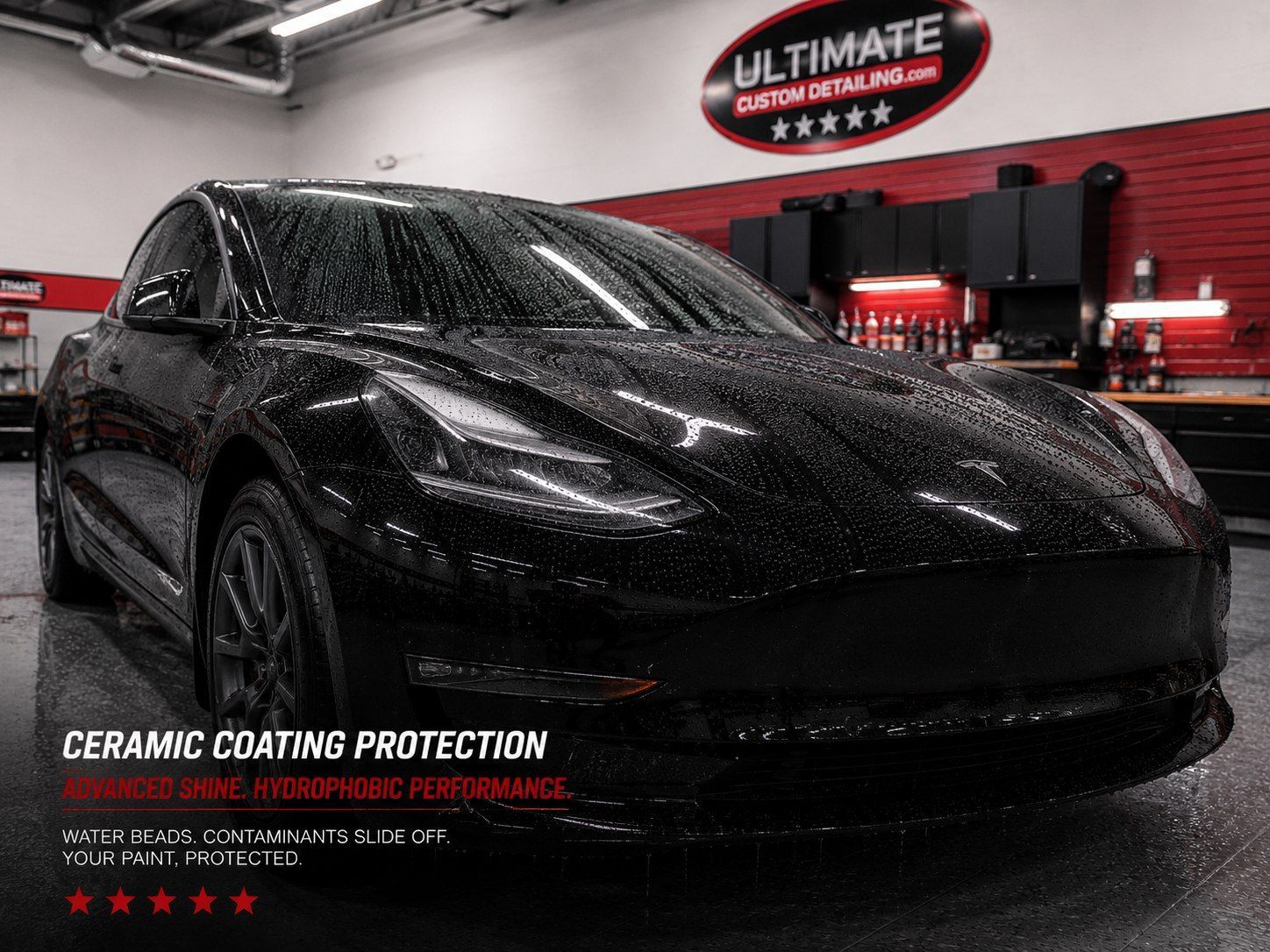 Black sports car in a red-lit garage with Ultimate Graphics logo and ceramic coating protection text