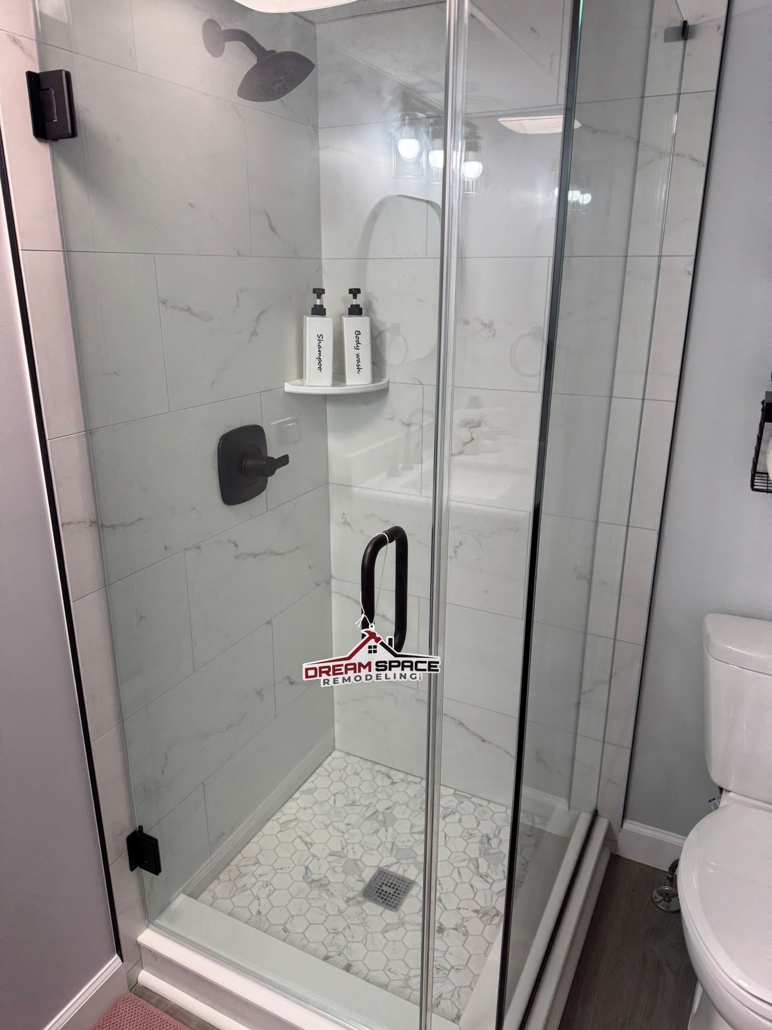 Compact basement bathroom remodel featuring 30x30 custom shower with glass enclosure | Manchester, MD