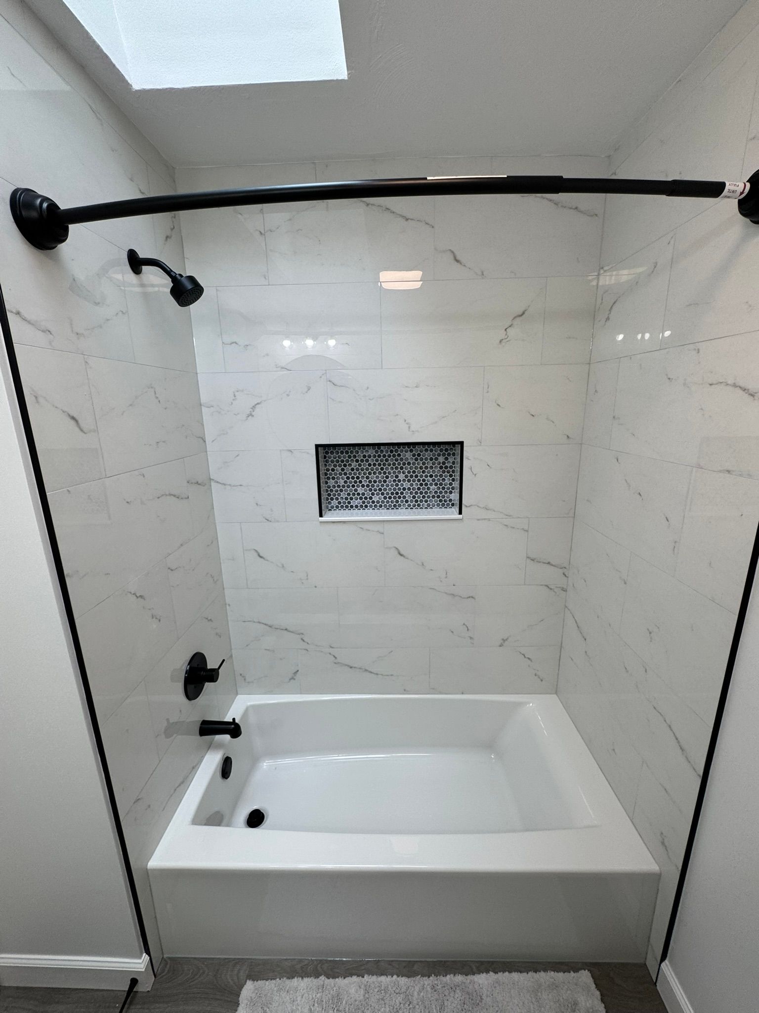 Hall bathroom renovation with 32x60 bathtub, full wall tile installation, and one niche. Manchester, MD