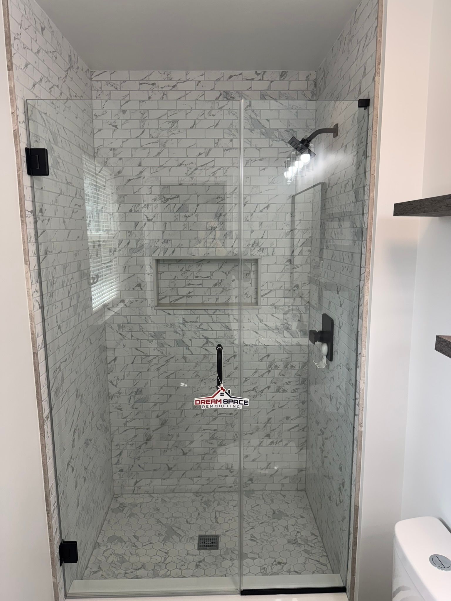Master bathroom shower 60 inches wide with small subway tiles up to ceiling and custom glass door | Owings Mills, MD