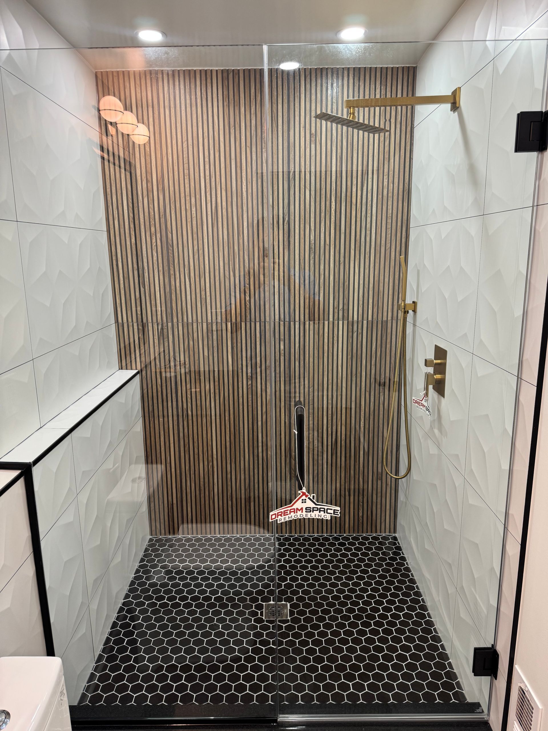 Contemporary bathroom remodel in Columbia, MD with frameless glass shower door.
