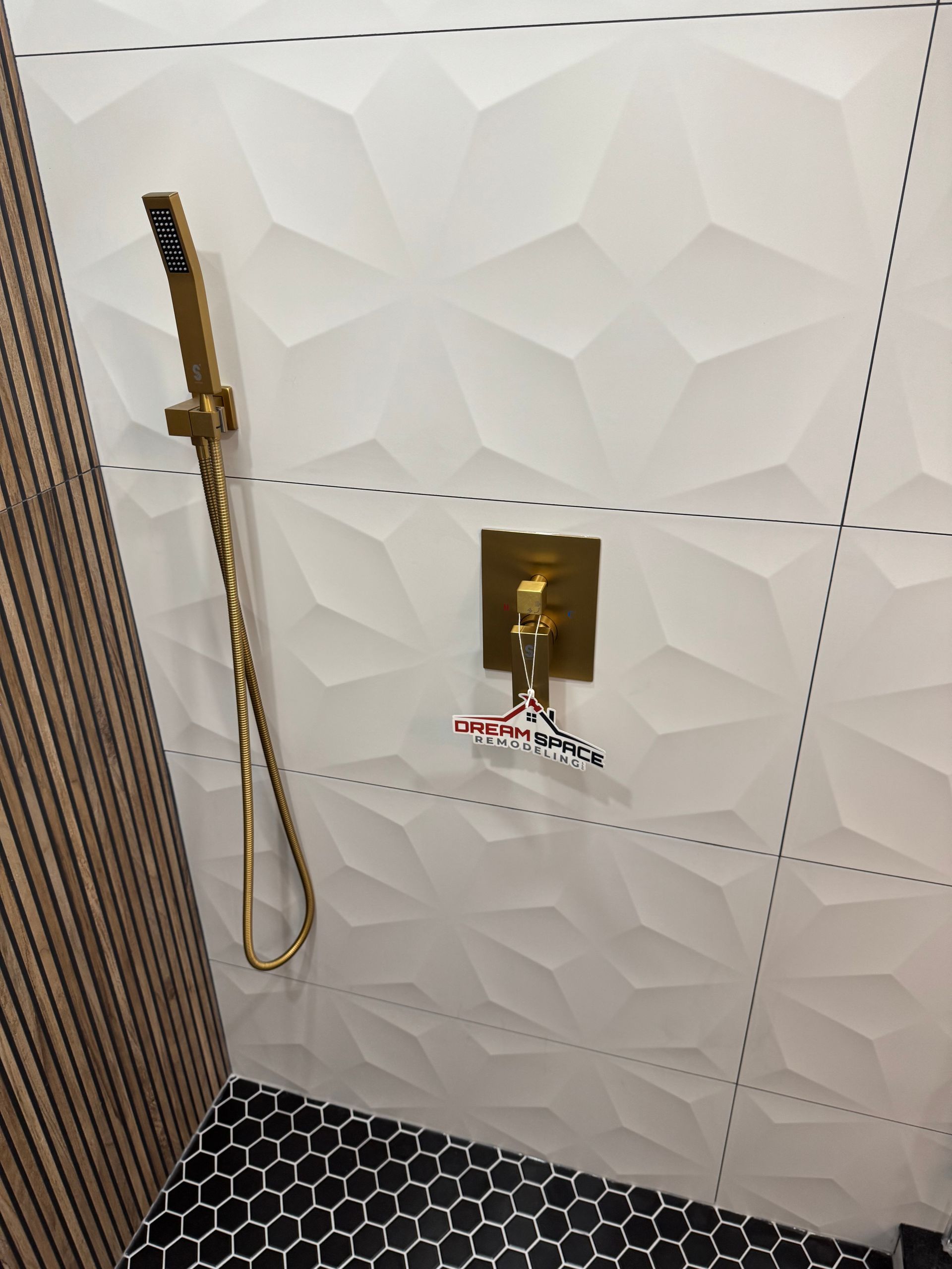 Modern bathroom remodel in Towson, MD with tiled shower up to the ceiling.