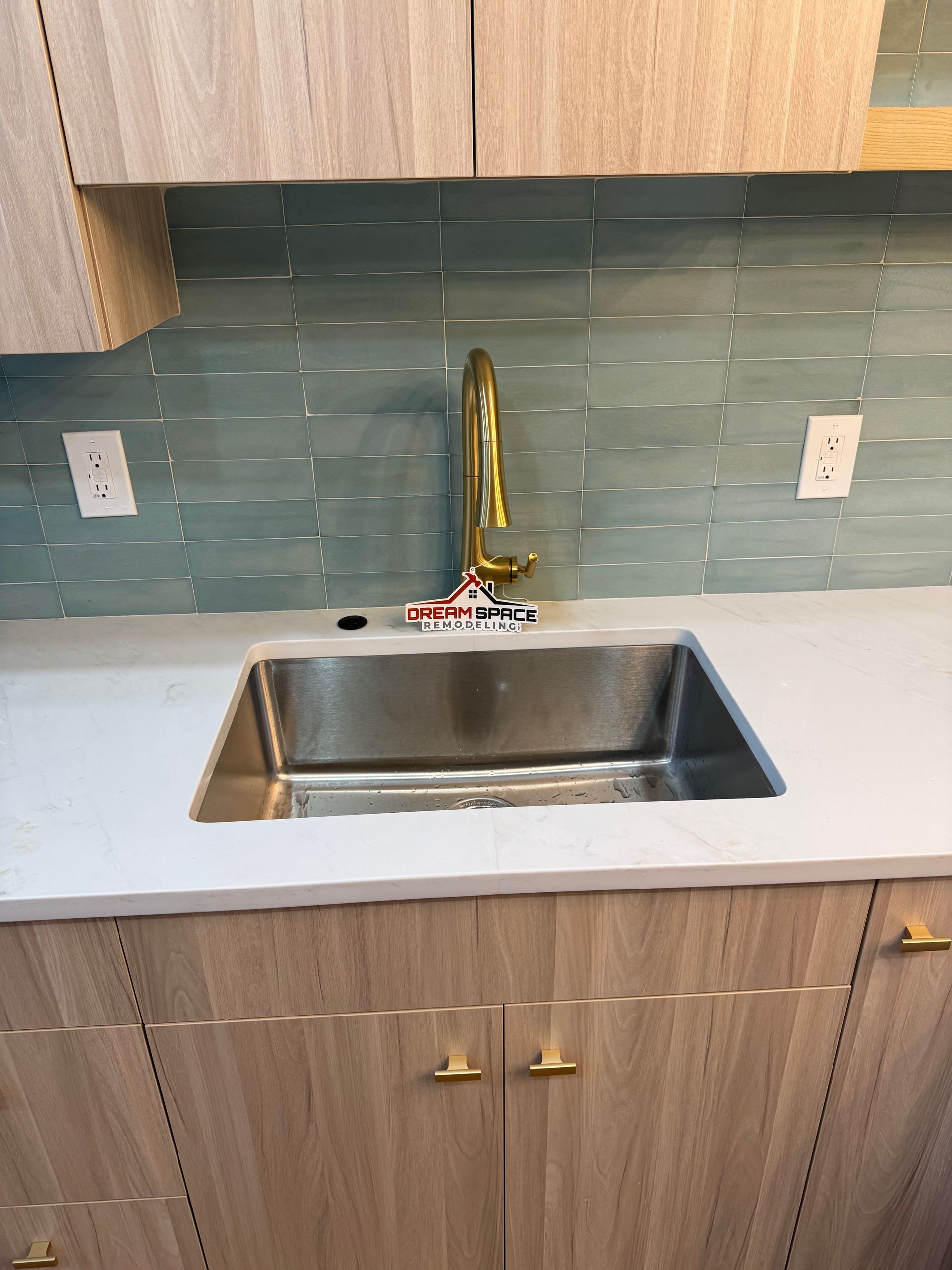 Modern remodeled kitchen with slab-style cabinets and push-up openers — view of peninsula