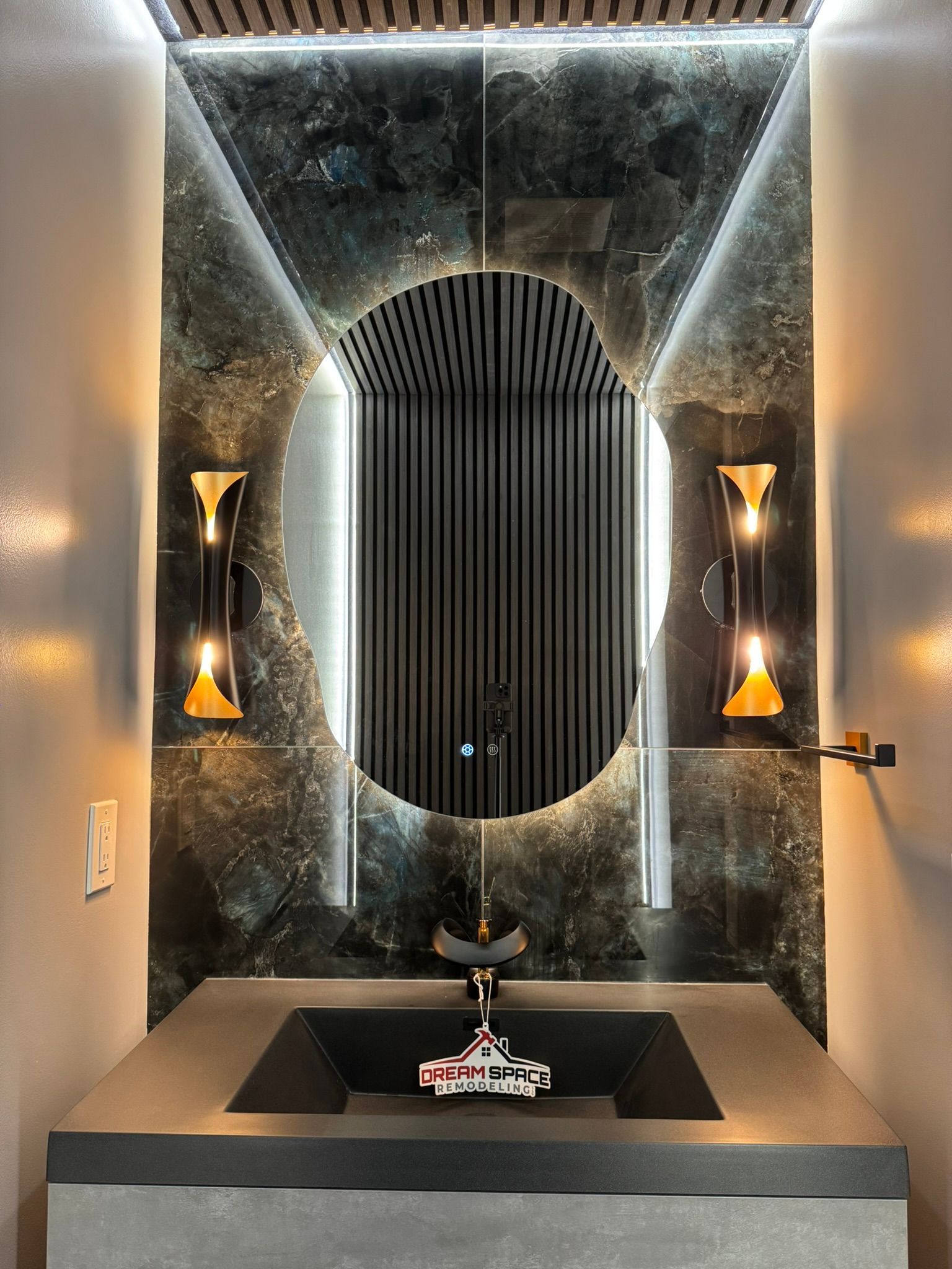 Contemporary bathroom remodeling services in Reisterstown, MD with stylish floating vanity, ambient lighting, and black & gold faucets