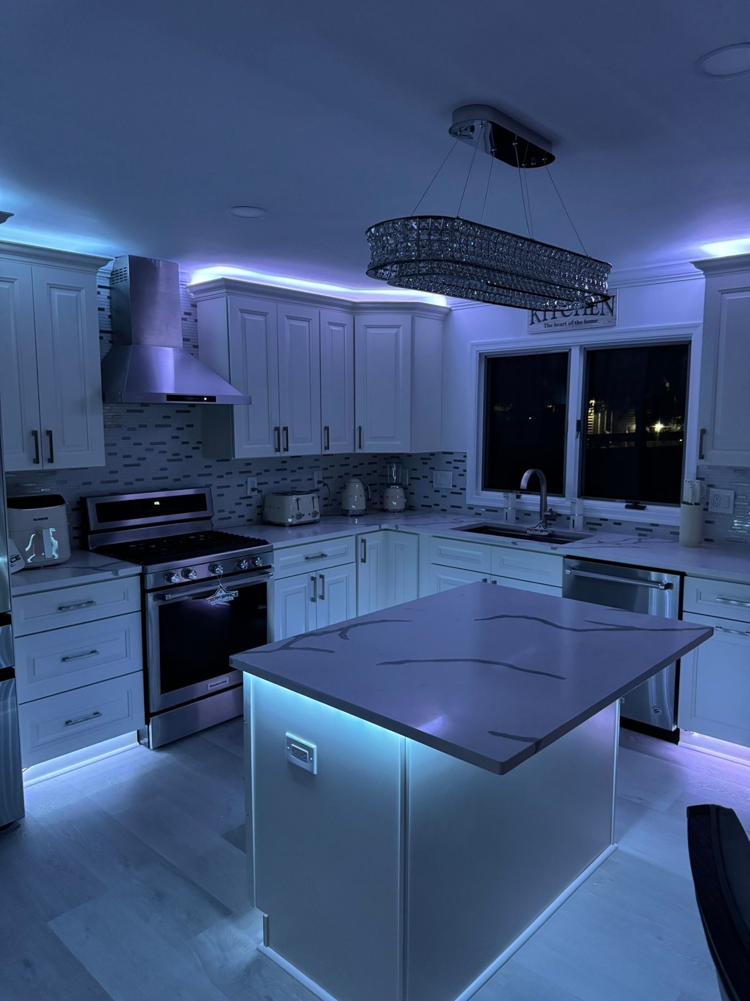 Luxury modern kitchen design with quartz waterfall island and under-cabinet lighting – Reisterstown MD