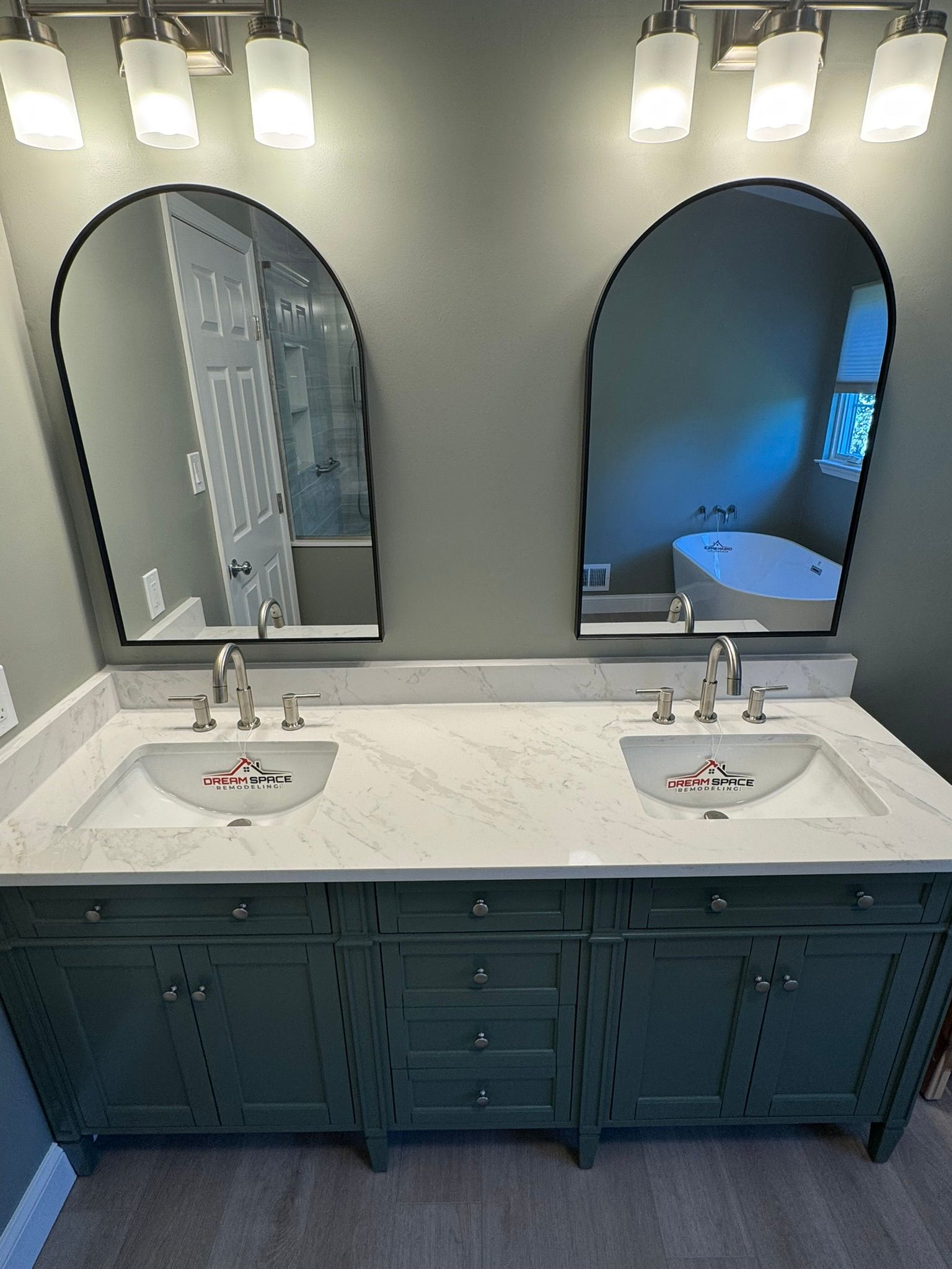Modern master bathroom featuring James Martin vanity with quartz countertop, arch mirrors, and sleek lighting – Columbia Maryland