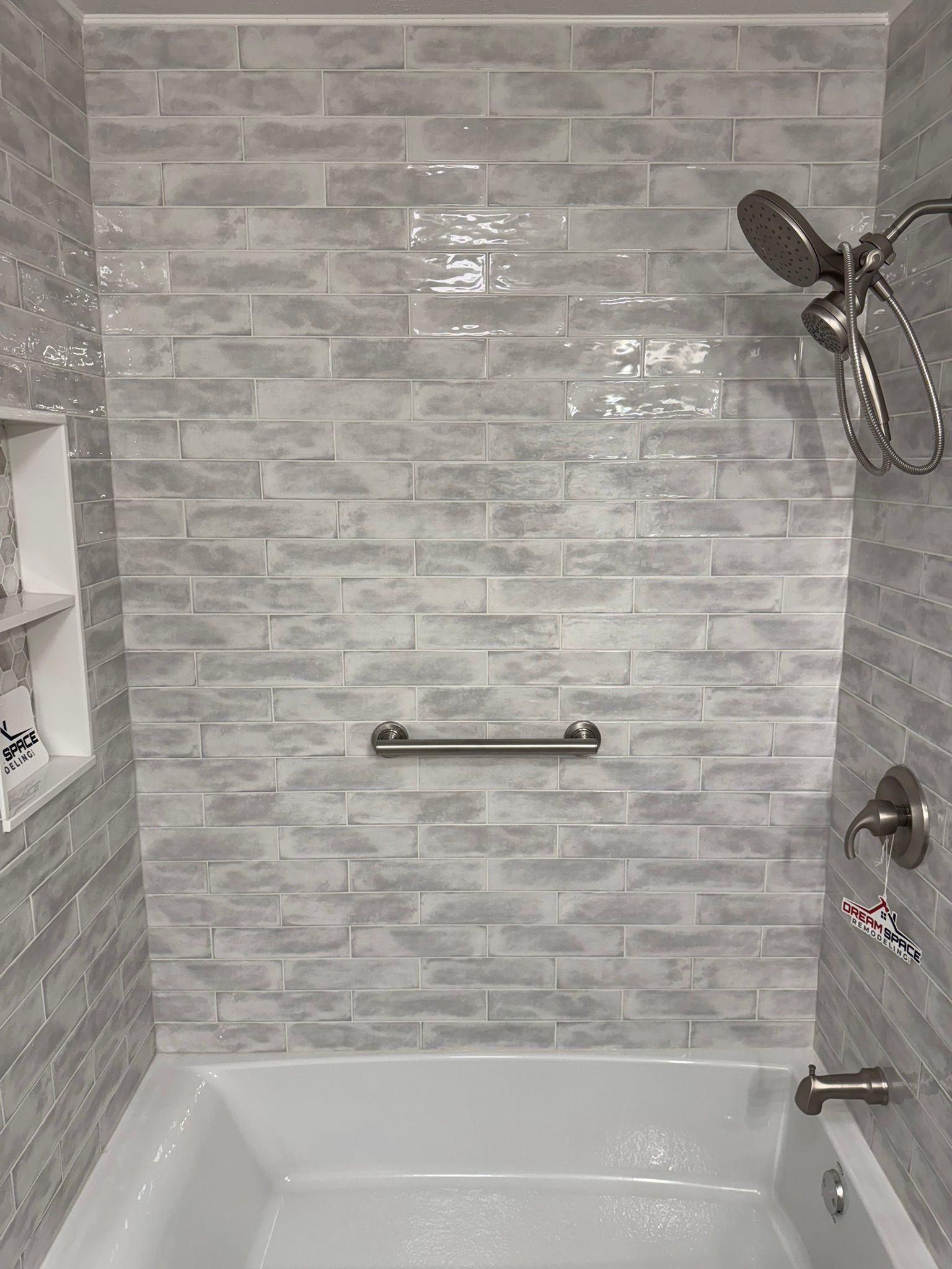 Elegant hallway bathroom remodel with bathtub, niche tile detail, and sleek vanity design – DreamSpace Remodeling Columbia MD