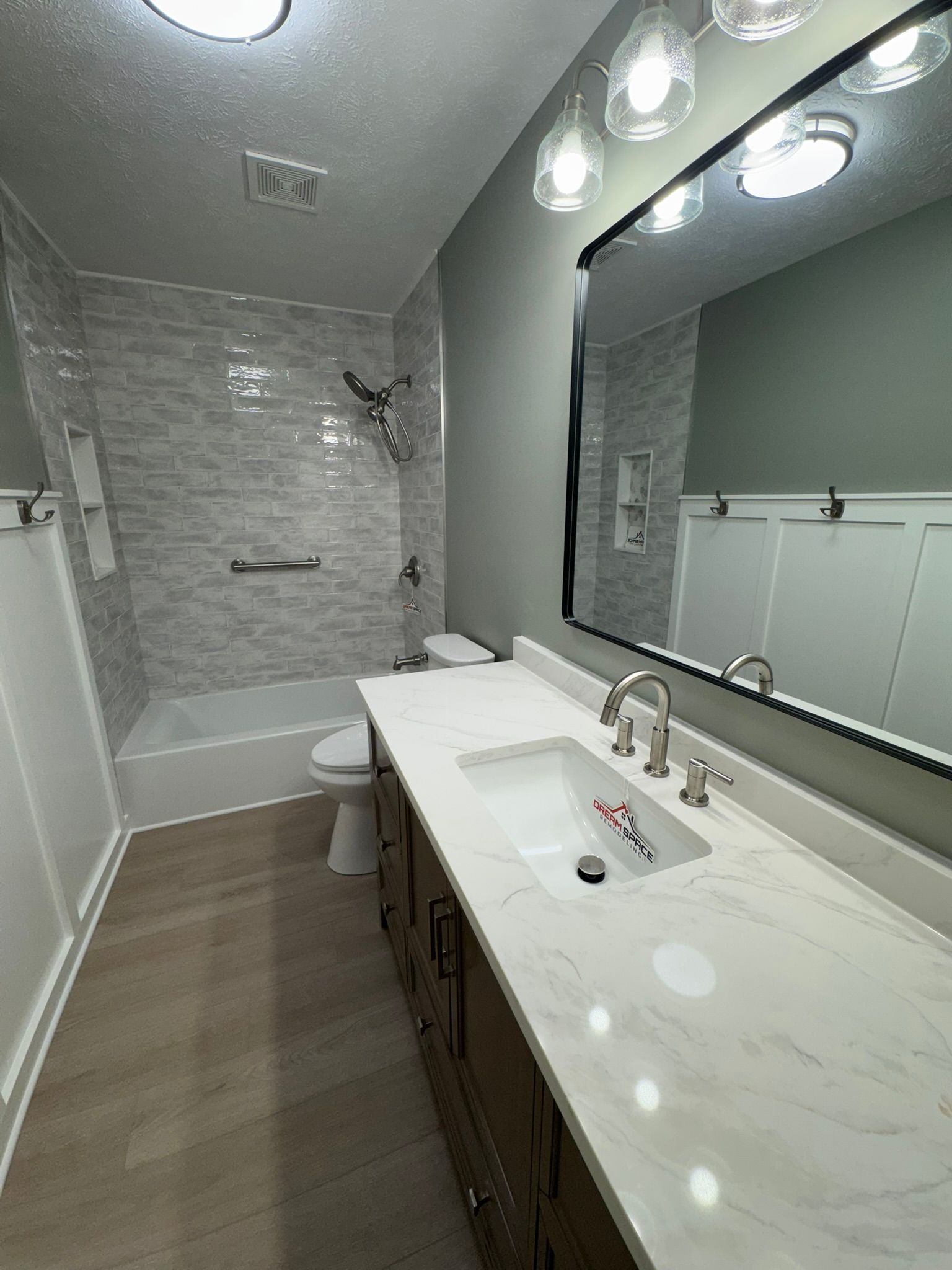 Contemporary hallway bathroom featuring quartz vanity top, stylish lighting, and modern fixtures – Columbia Maryland