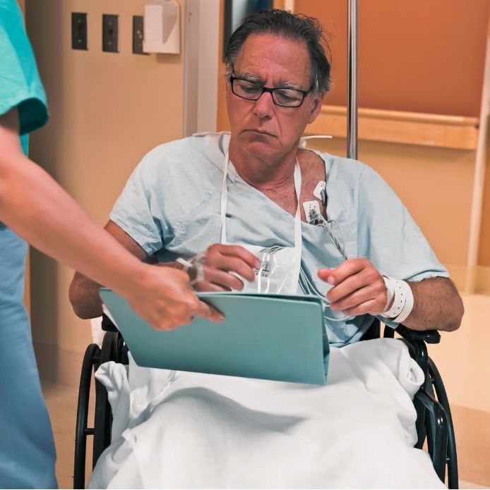 male patient reviewing paperwork