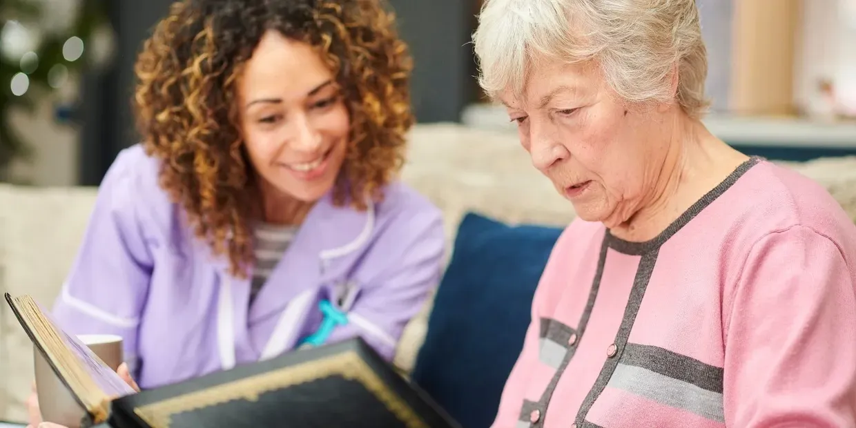 Carer helping client view photo album