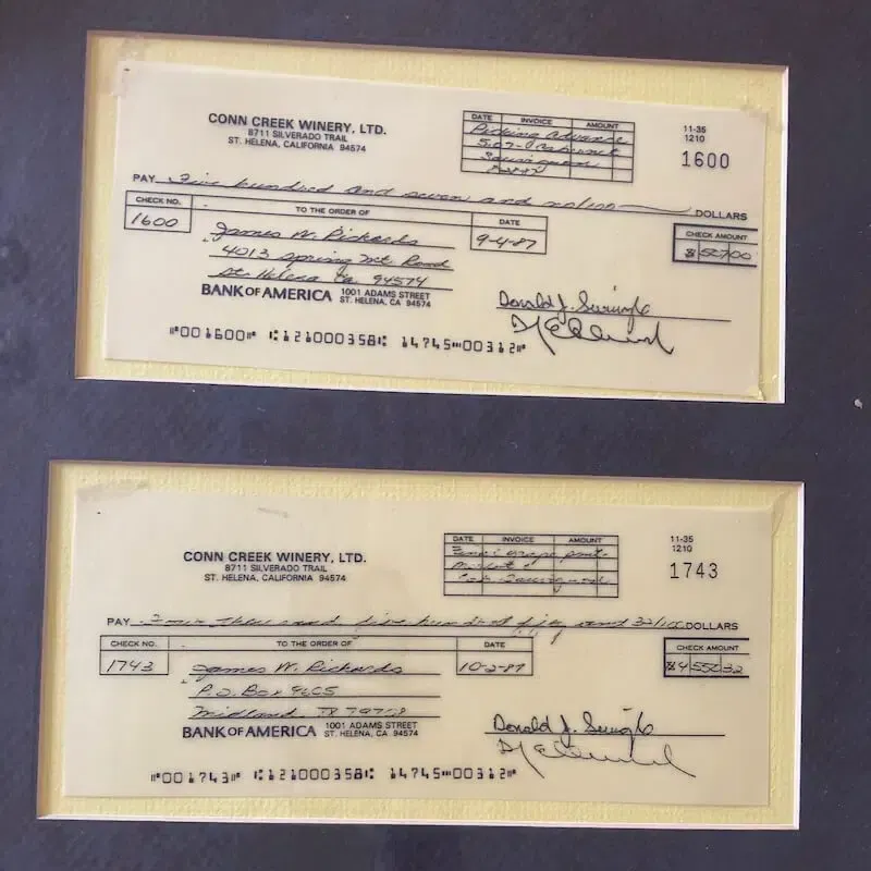 Framed vintage checks from Conn Creek Winery made out to James M. Richards.