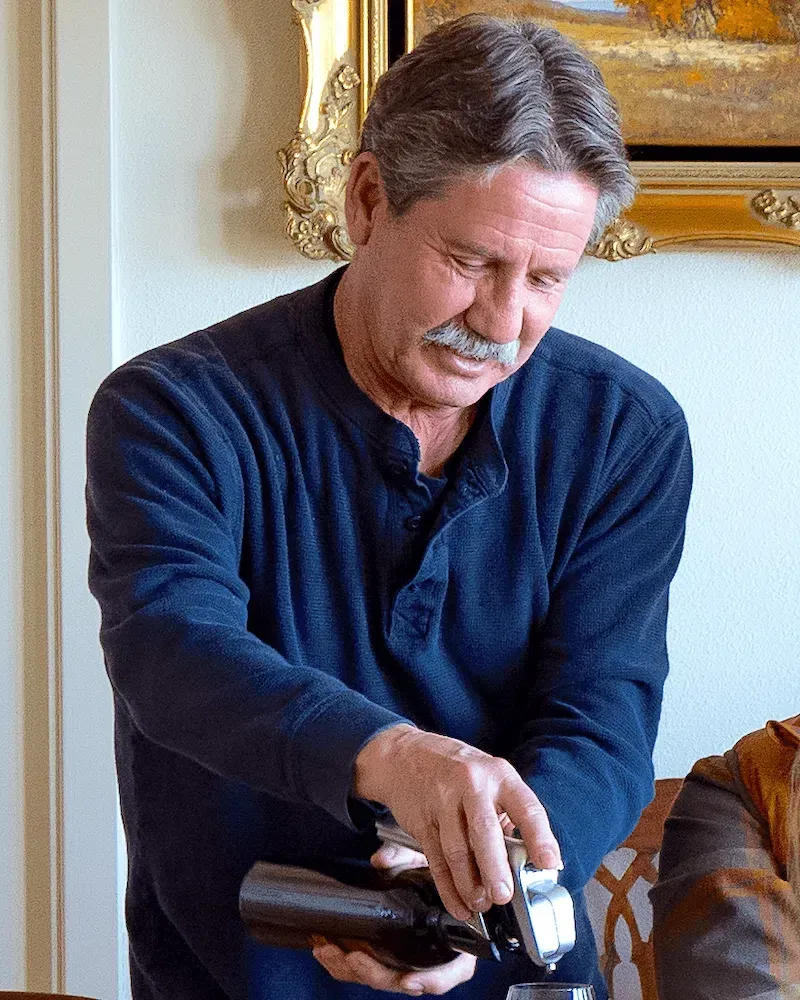 Owner of Napa winery Paloma Vineyard pouring wine during a tasting experience inside the estate.