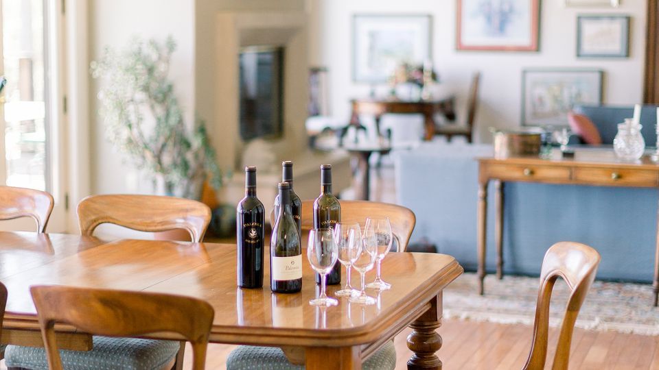 Napa Valley award winning wines displayed on tasting table with Paloma Vineyard wines and glasses in