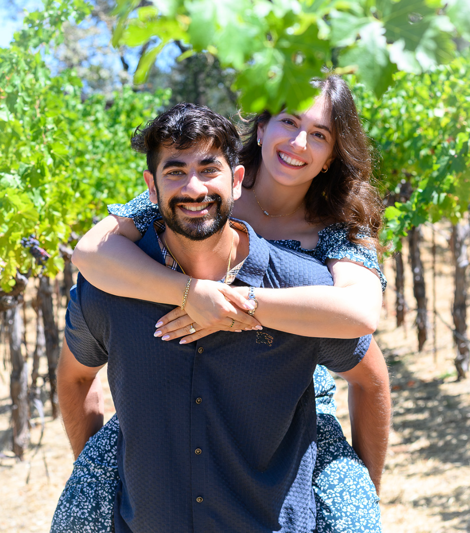 Rohan and Gabi share a piggyback moment celebrating their engagement at Paloma Vineyard in Napa Valley. 