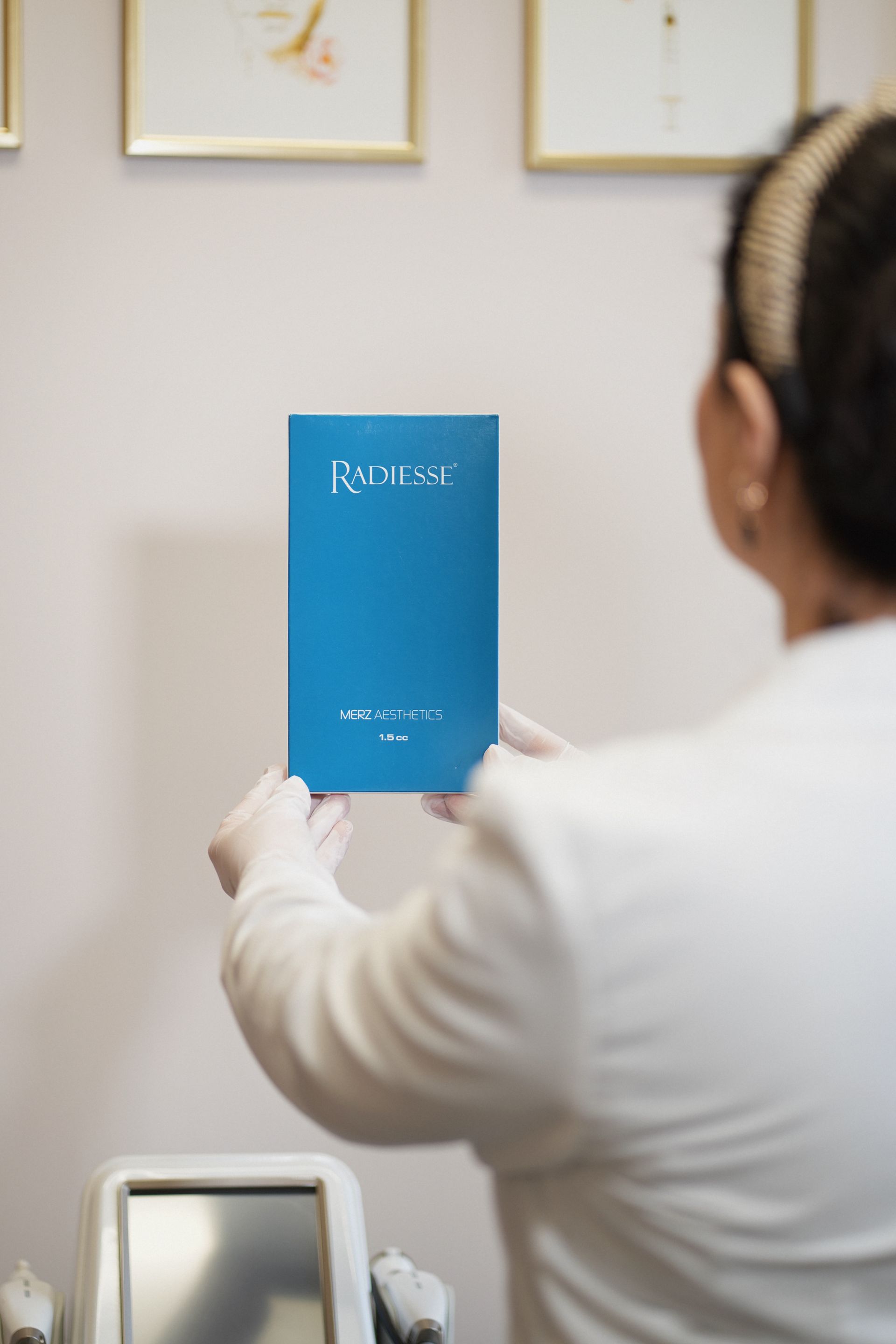 A woman is holding a blue book in her hands.