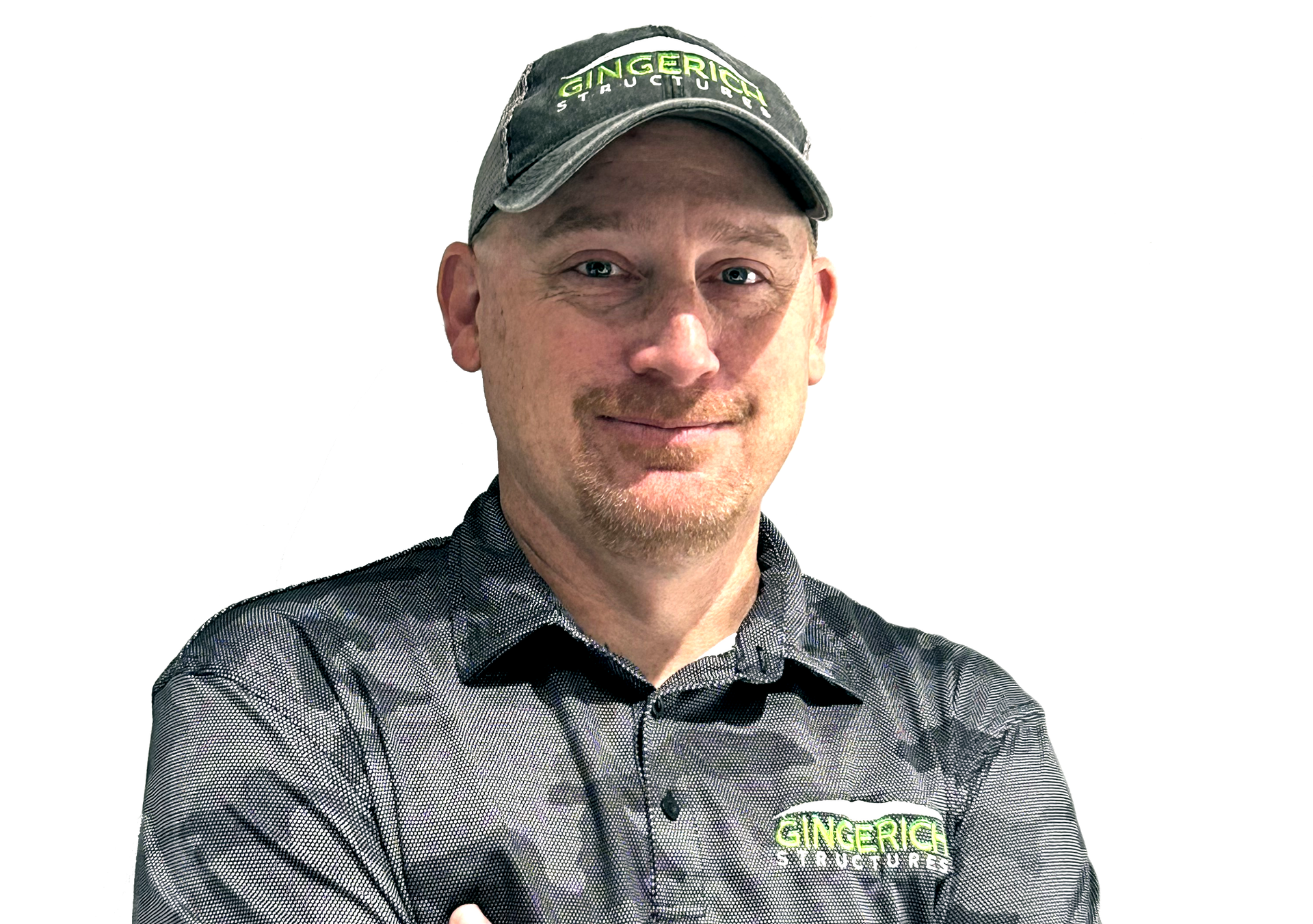 Man in a dark cap and patterned polo shirt, smiling against a white background.