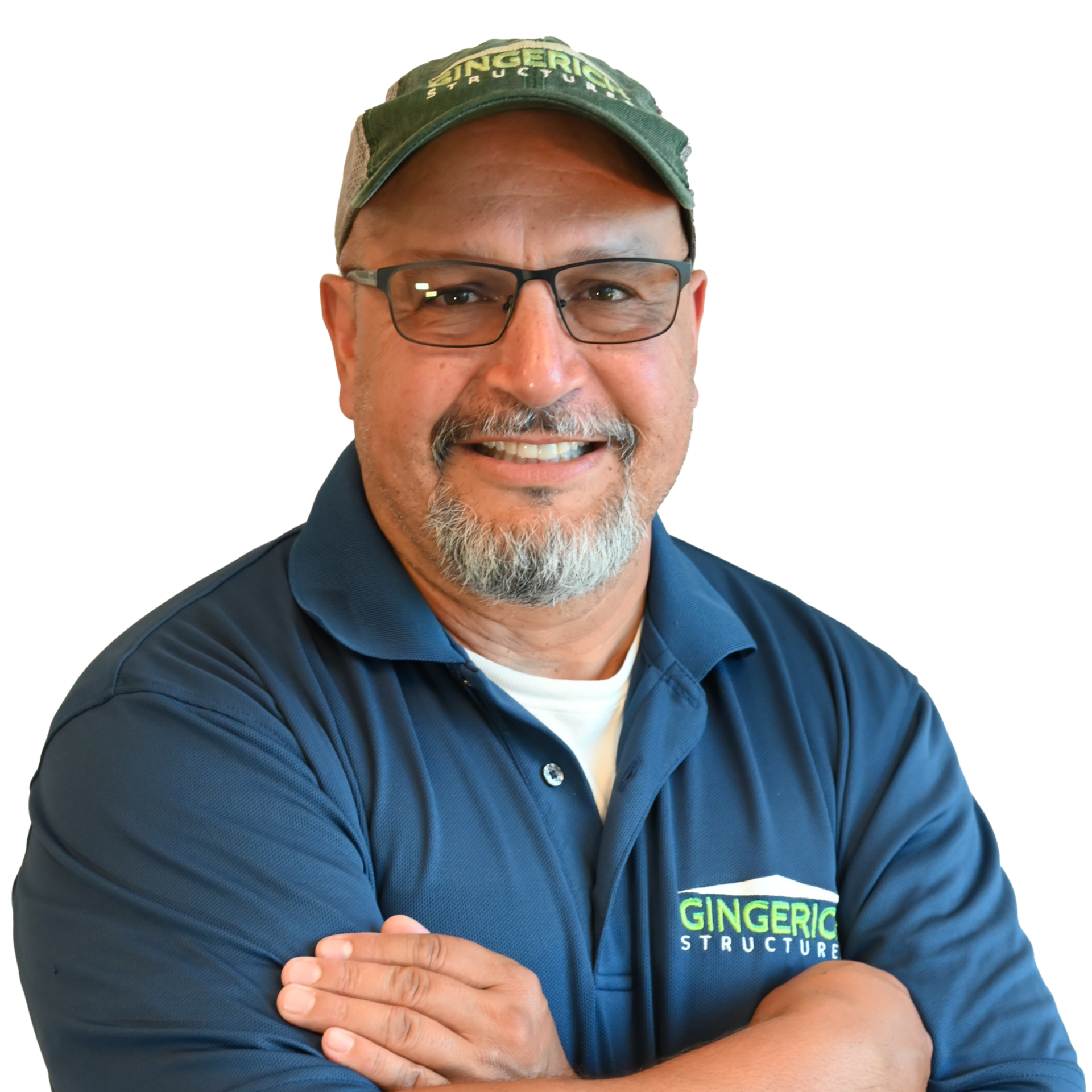 Man with glasses and beard wearing a hat and polo shirt, arms crossed, smiling.