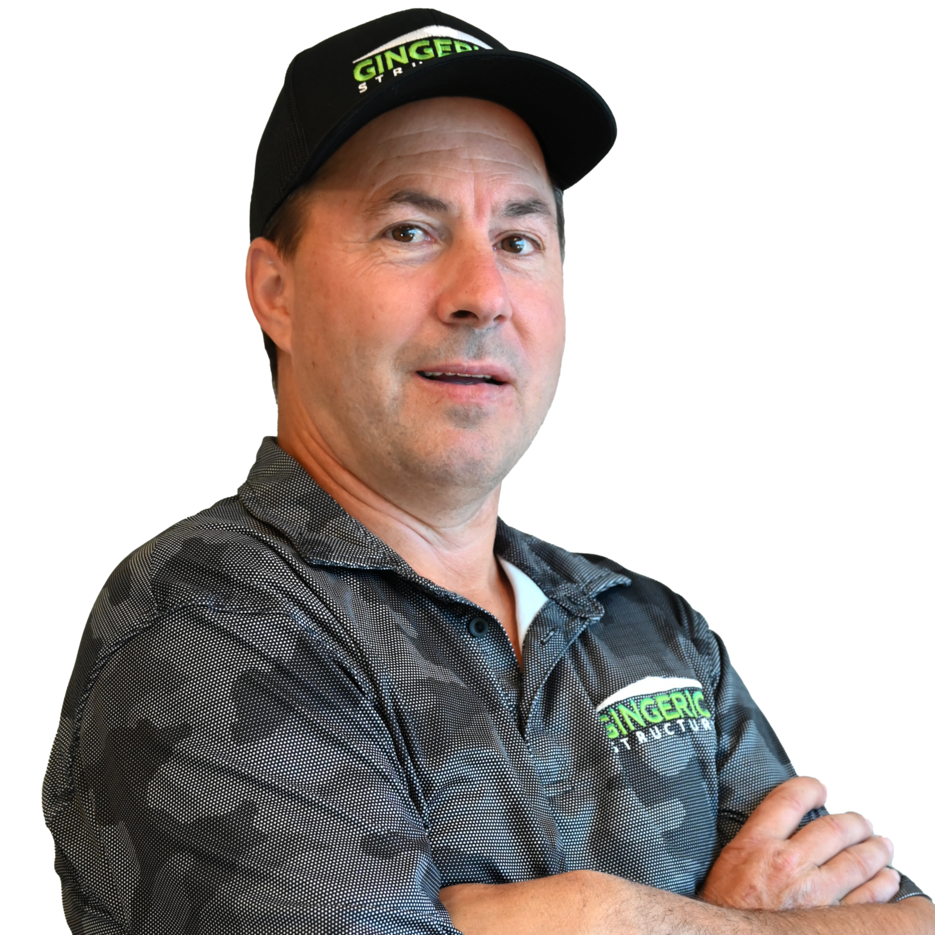 Man wearing a black cap and patterned shirt, smiling, with a logo on his cap and shirt.