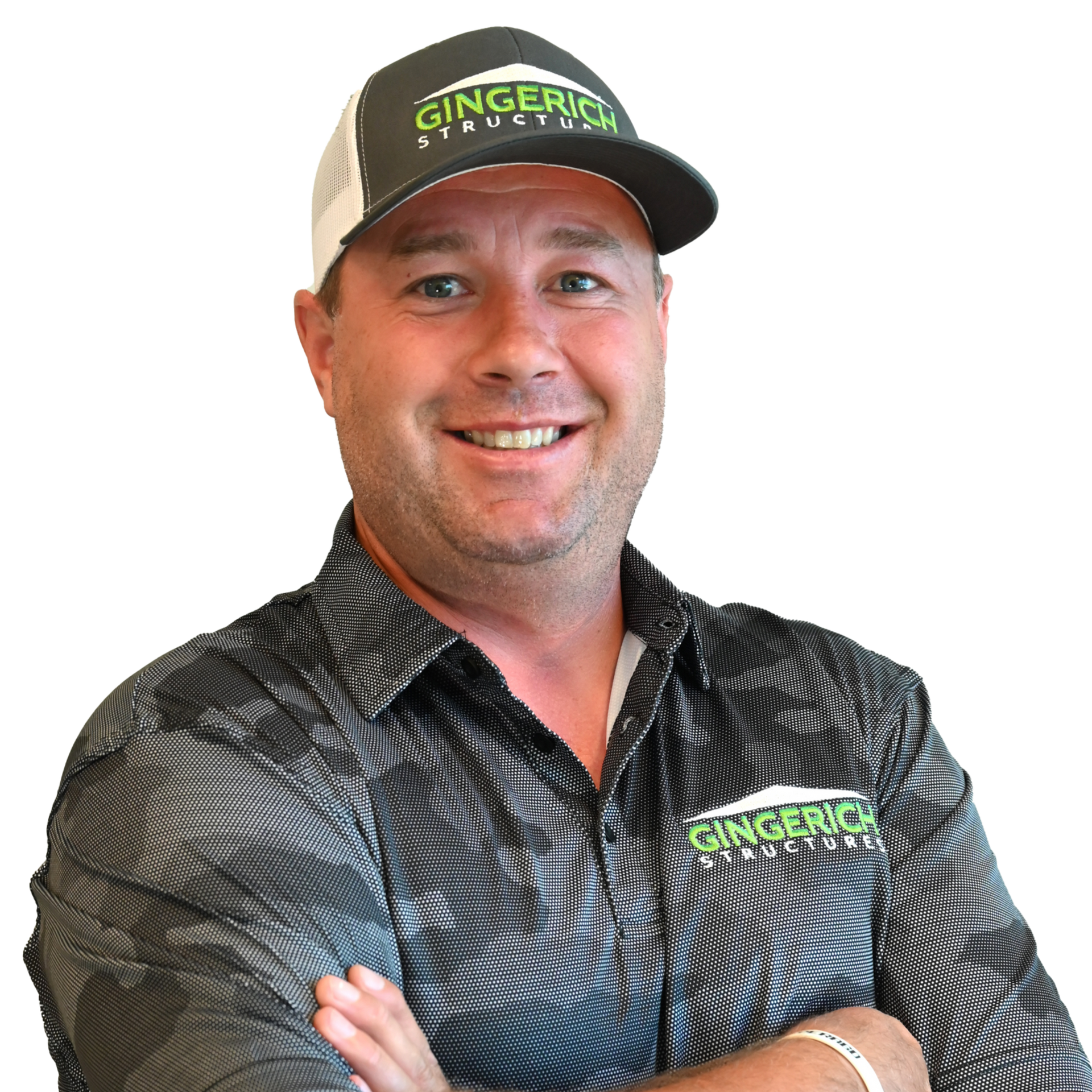 Man wearing a baseball cap and a shirt with a company logo, smiling with arms crossed.