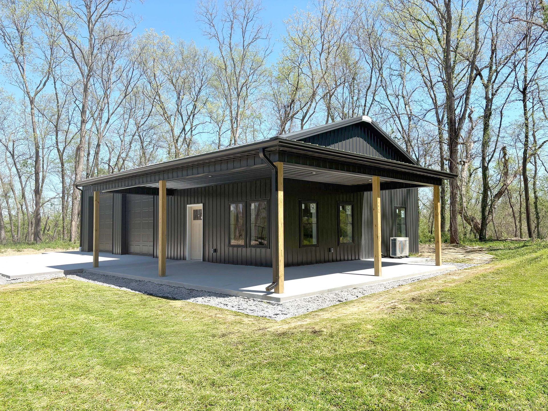 Post-frame pavilion under construction showing open wood-post framing and metal roof