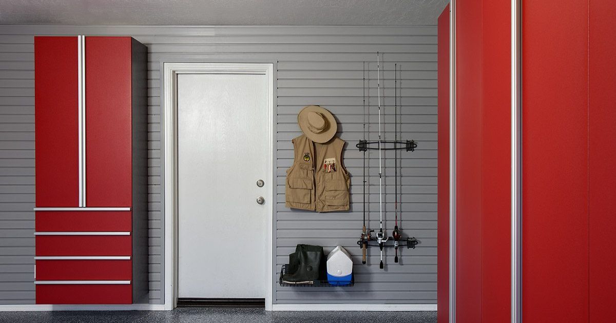 Gray walk-in closet with built-in storage, desk, and hanging clothes.
