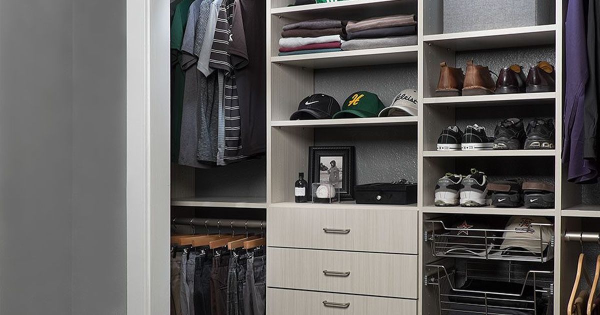 Walk-in closet with shelves and drawers holding clothes, shoes, and accessories.