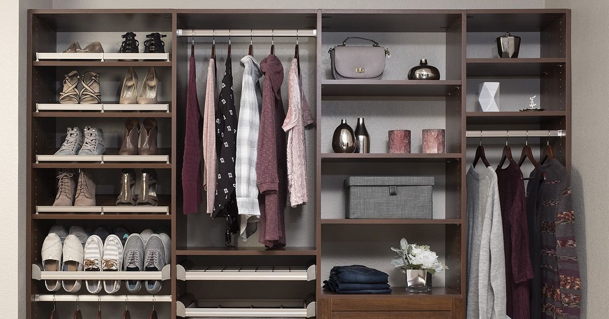 Reach In Closet organization system with shelves and hanging rods; clothes and accessories neatly arranged.