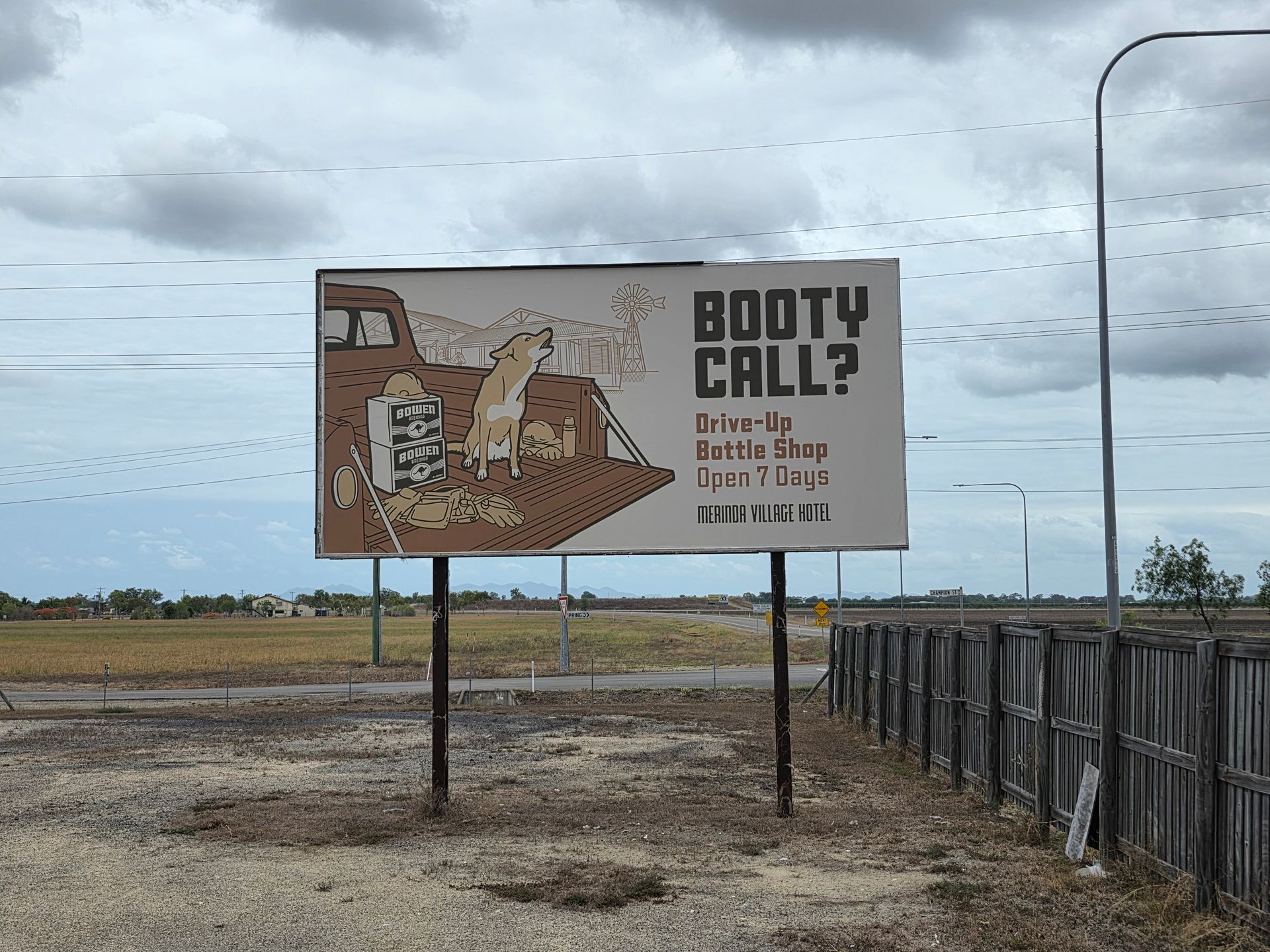 Billboard in a Field Reading “booty Call?” With a Woman Illustration — Lehmann Print Solutions in Bowen, QLD