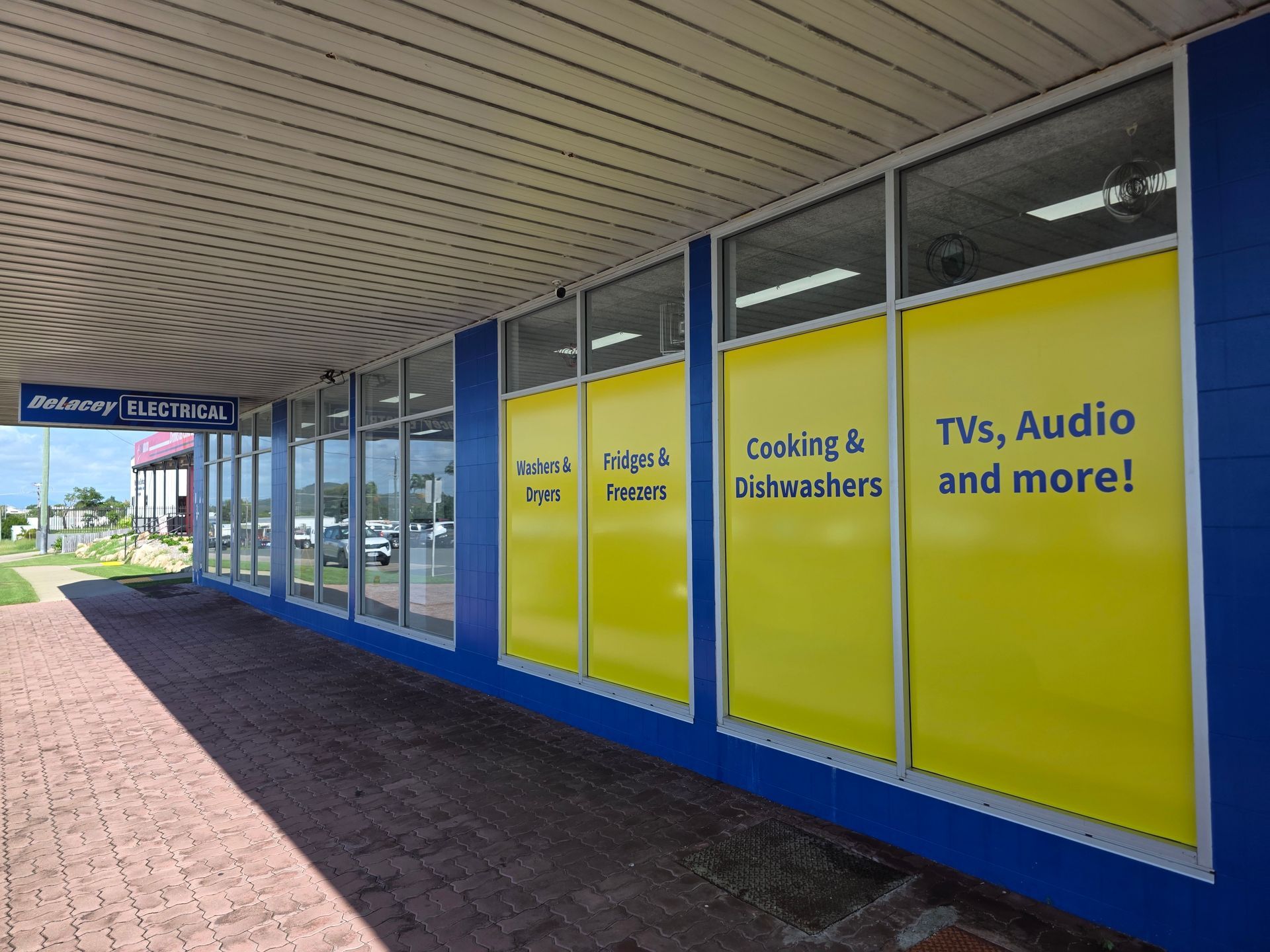 Storefront With Yellow Window Signs — Lehmann Print Solutions in Bowen, QLD