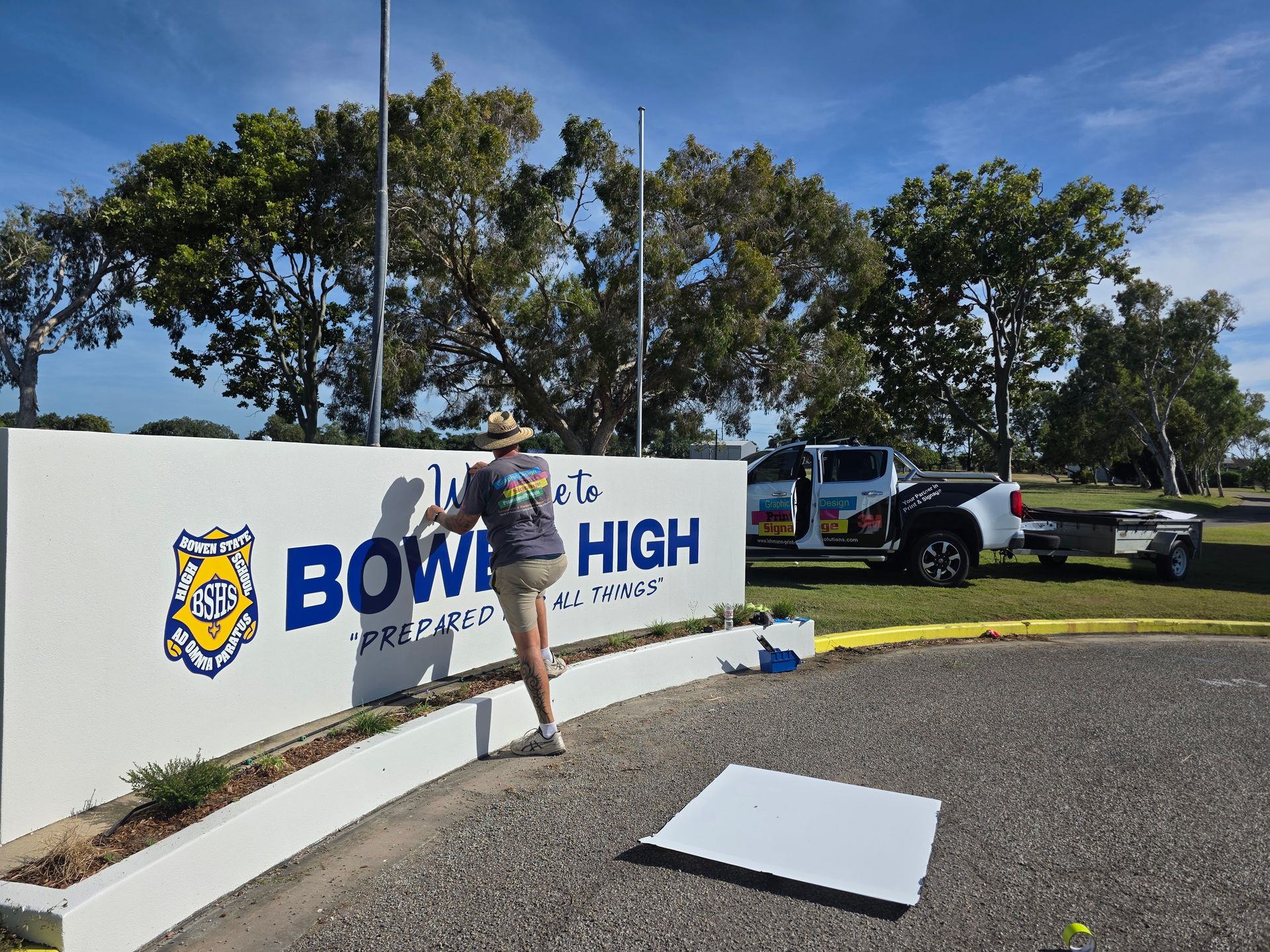 Person Installing a Sign — Lehmann Print Solutions in Bowen, QLD