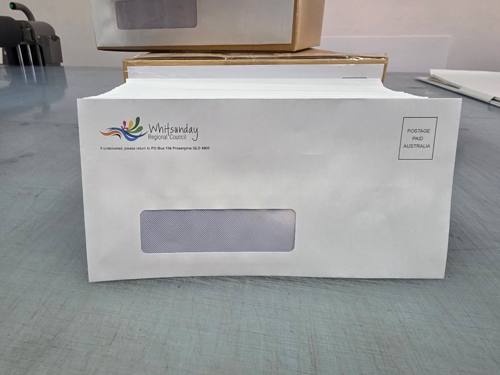 White paper box with a logo and rectangular label on a table, viewed from the front. — Lehmann Print Solutions in Bowen, QLD