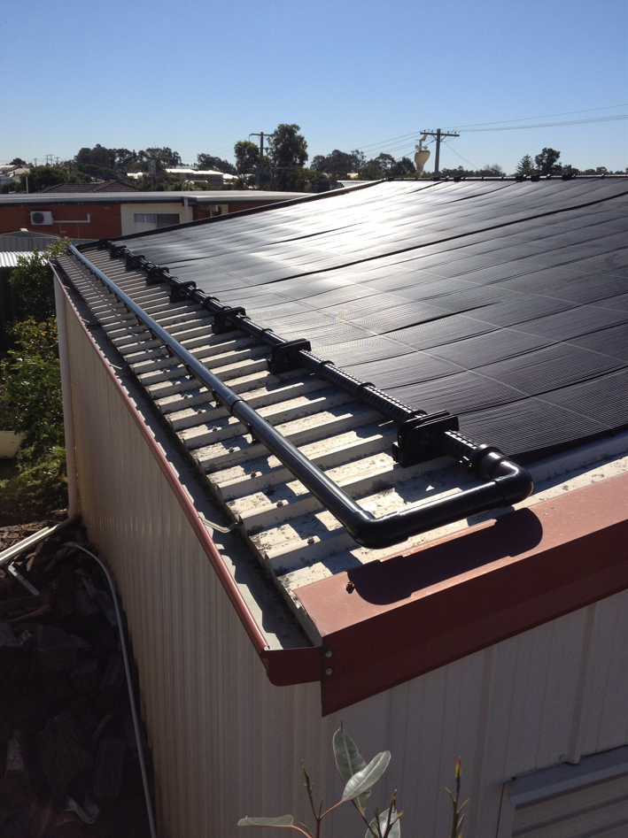 A Roof With a Lot of Solar Panels on It — Newcastle Solar Pool Heating Systems In Lake Macquarie, NSW