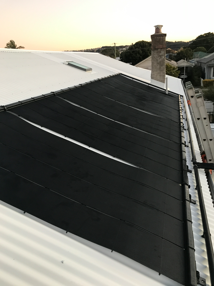 A Roof With a Lot of Solar Panels on It — Newcastle Solar Pool Heating Systems In Cessnock, NSW