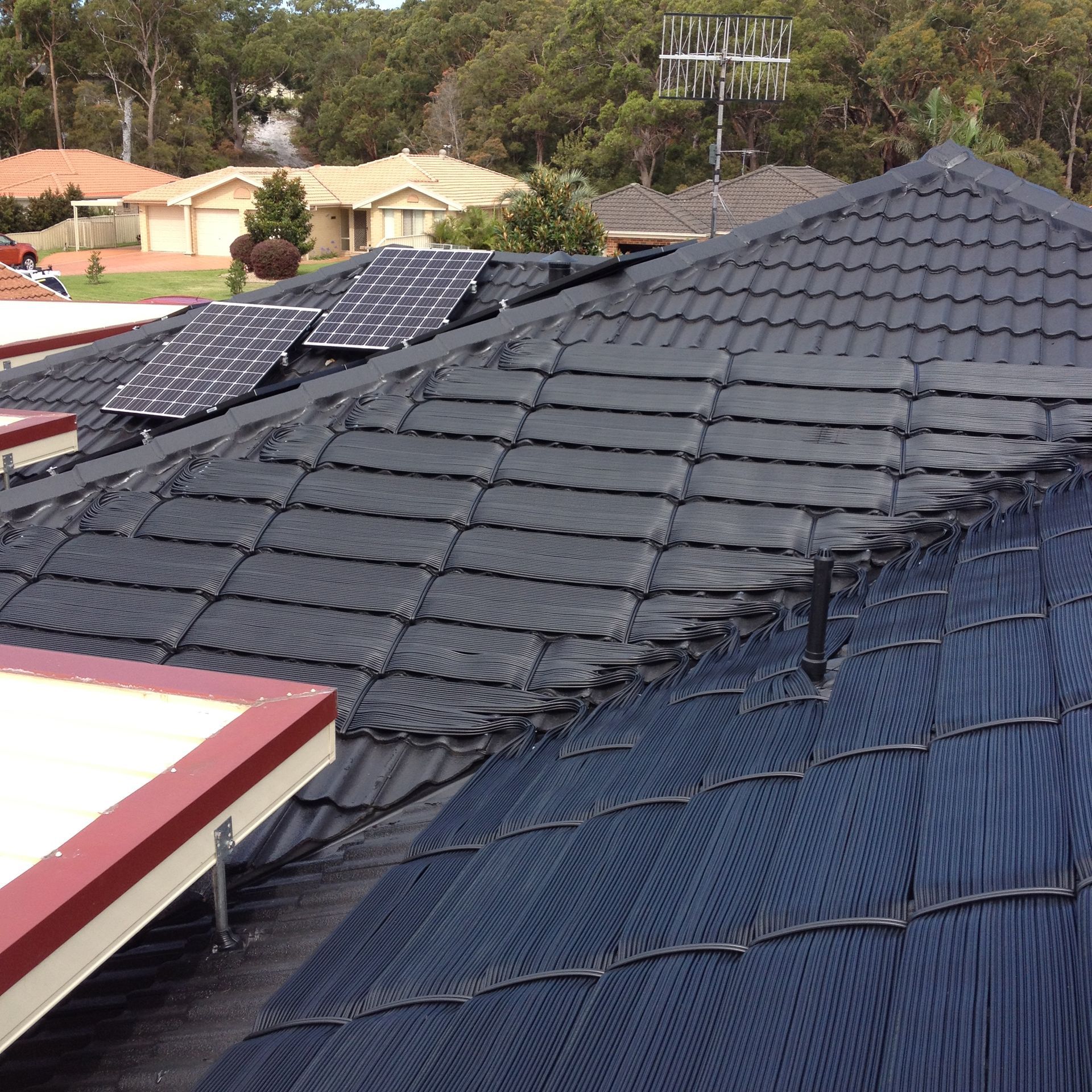 A Roof With a Lot of Solar Panels on It — Newcastle Solar Pool Heating Systems In Elermore Vale, NSW