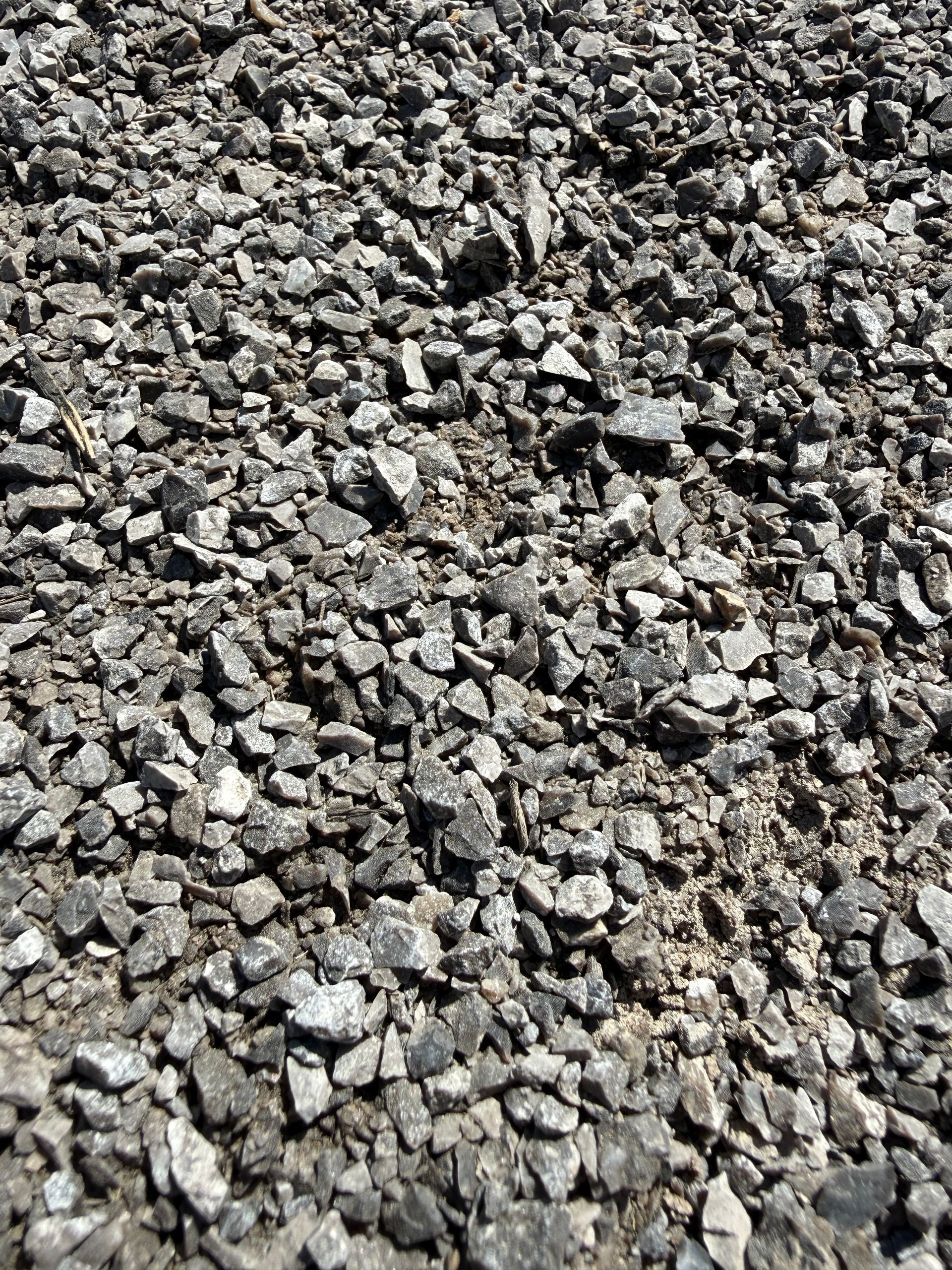 Close-up of rough gray gravel and small stones covering the ground