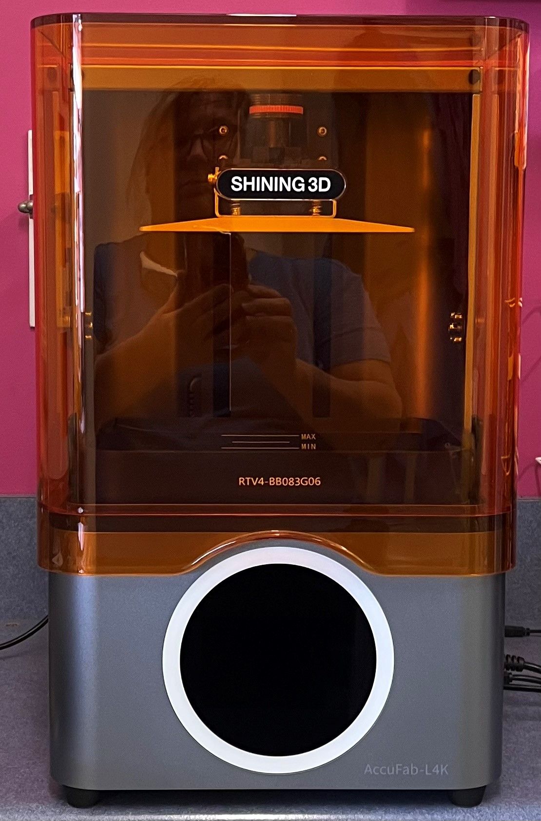 A shiny 3d printer is sitting on a table