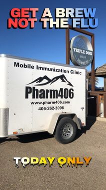 Mobile immunization clinic offering flu shots. Sign reads 
