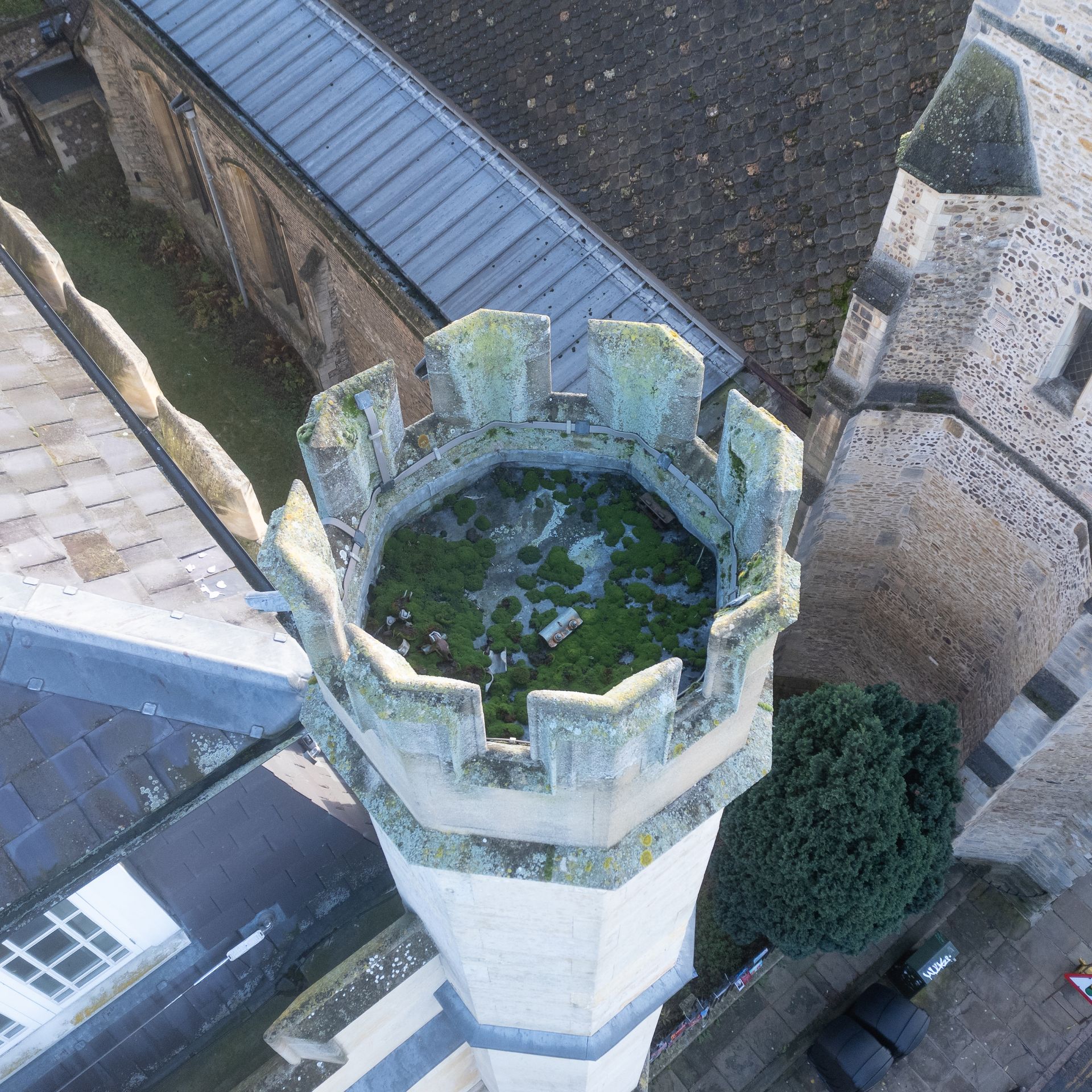 Drone roof survey shows previous scaffolding brackets left in the tower of this old building in Cambridge