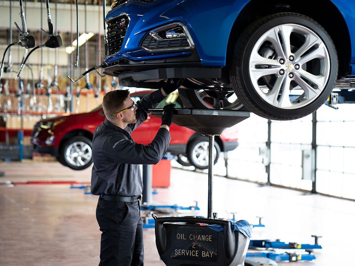 Vehicle on a lift in the shop bay during an oil change