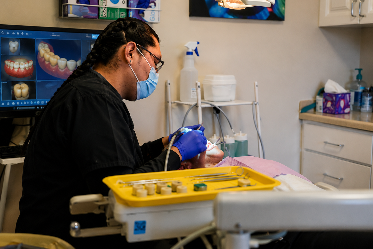 Medical professional wearing mask and gloves examining a patient in a clinic room