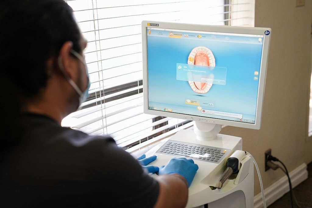 Person using a desktop computer showing a brain scan in a clinic office