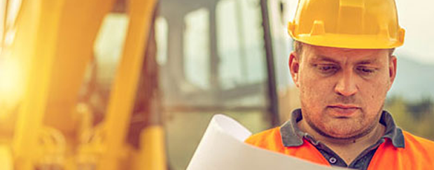 Constructor In Front Of Backhoe — Minden, LA — McInnis Insurance Agency, Inc.