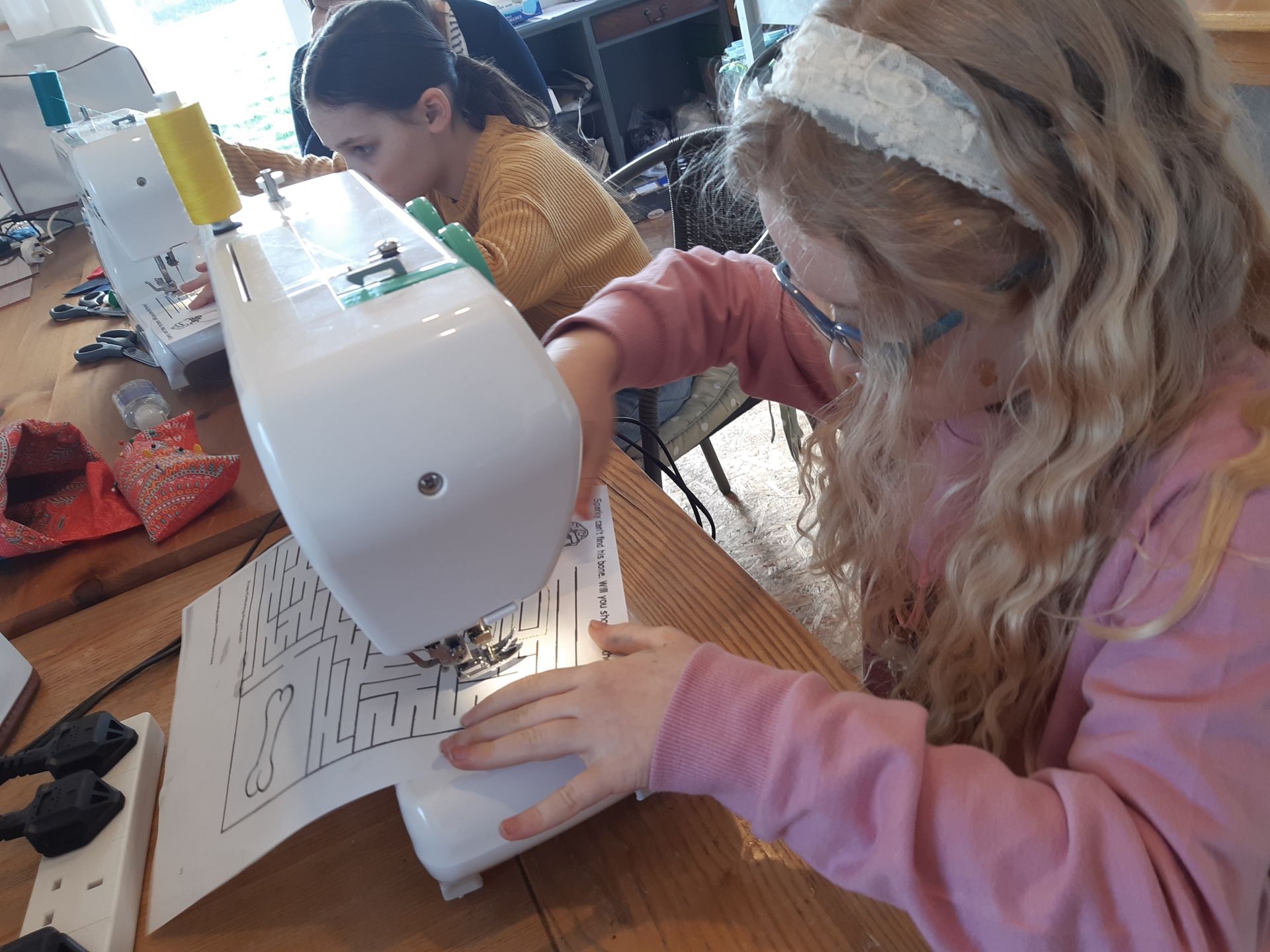 child using sewing machine